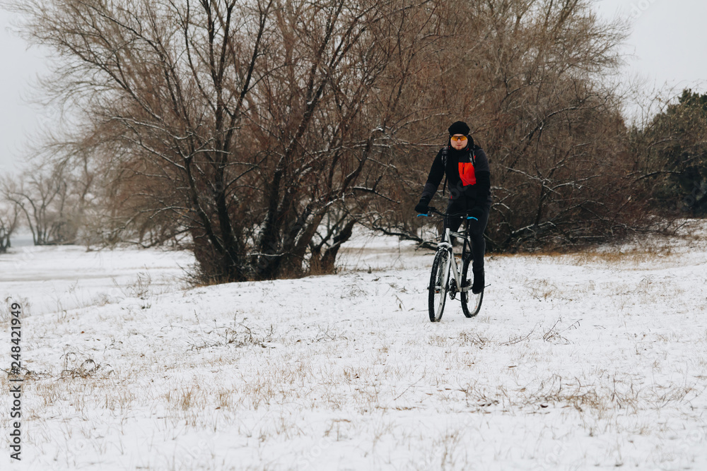Man on a bike in the winter forest