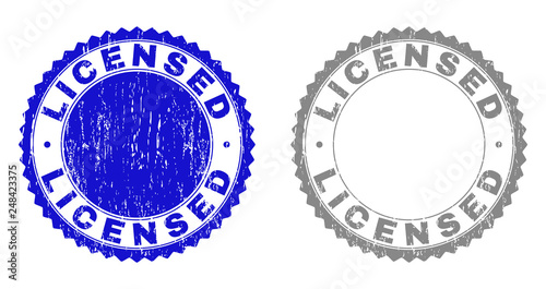 Grunge LICENSED stamp seals isolated on a white background. Rosette seals with distress texture in blue and grey colors. Vector rubber stamp imitation of LICENSED label inside round rosette.