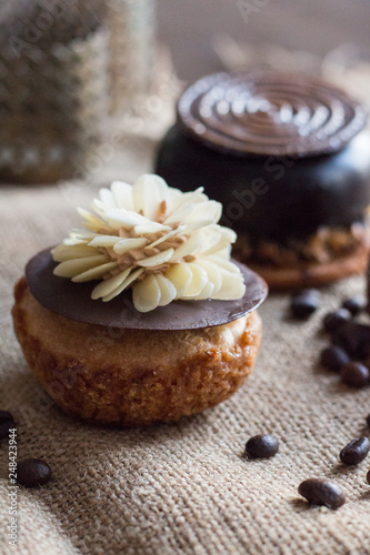 Two chocolate cakes lie on a sacking on a background of coffee.