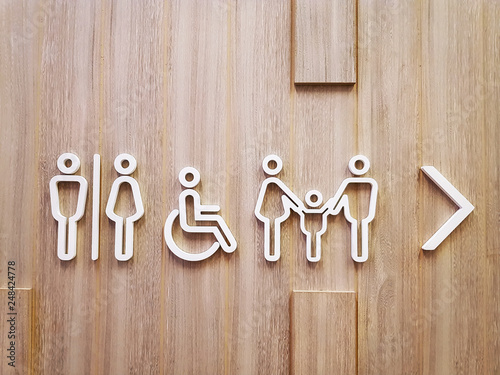 Various Designs of White Toilet Symbols on Wooden Wall