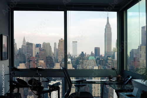 View of skyscrapers of  New York City (Manhattan) through windows of apartment. Top view of midtown of Manhattan. USA
