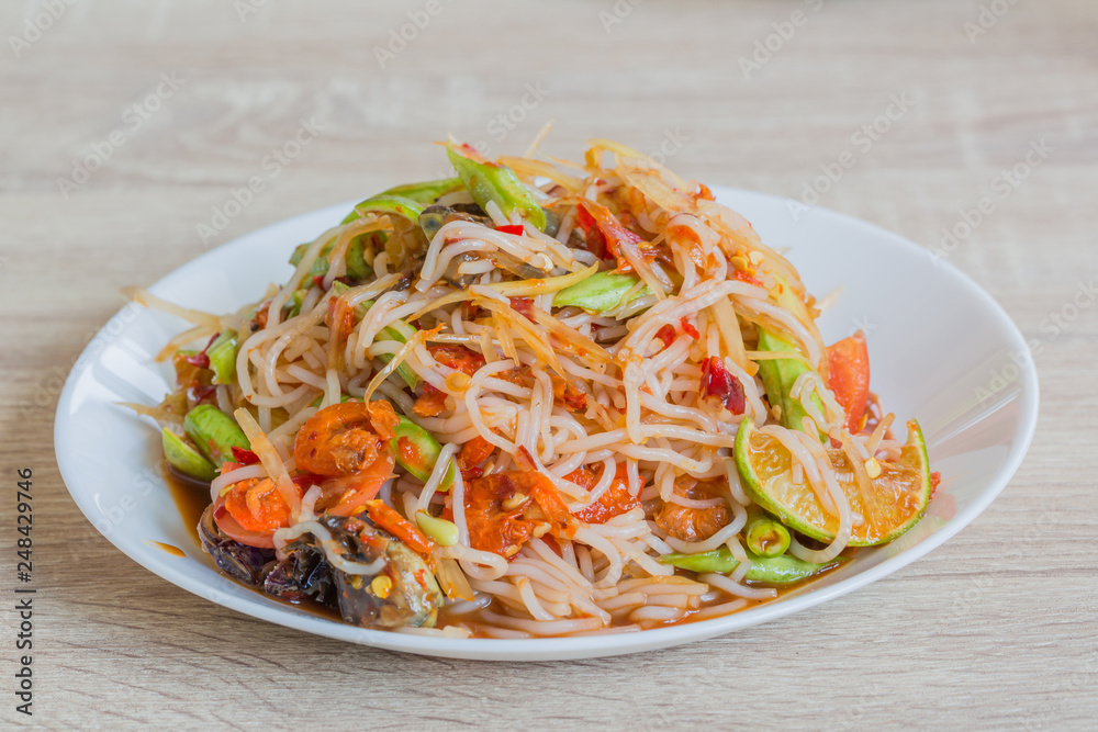 papaya salad, black crab and pickled fish in white dish, delicious thailand food papaya salad, black crab and pickled fish in white dish, delicious thailand food