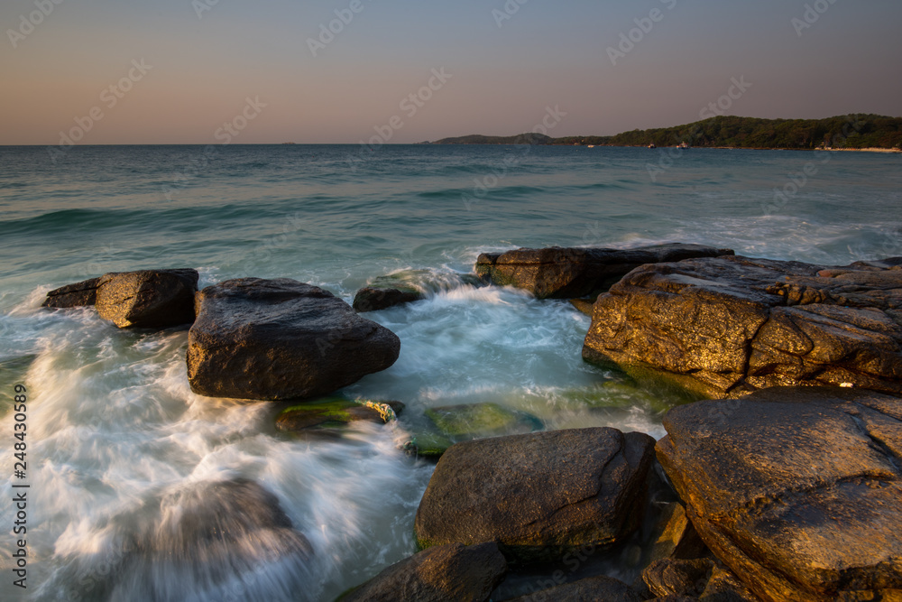 Beautiful sunrise over the beach in Ko Samet, rocks and sea waves, Thailand