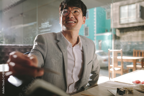 Businessman paying with contactless credit card at restaurant photo