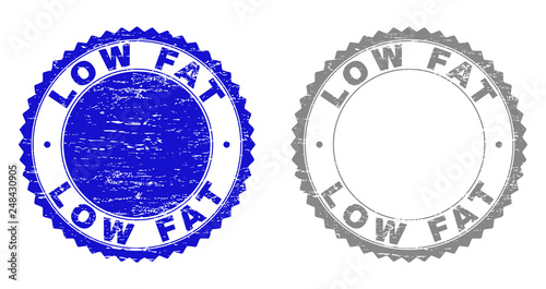 Grunge LOW FAT stamp seals isolated on a white background. Rosette seals with grunge texture in blue and gray colors. Vector rubber stamp imprint of LOW FAT tag inside round rosette.