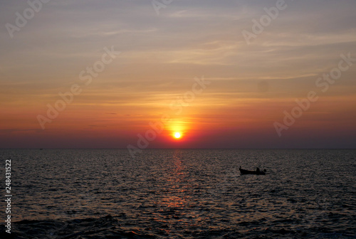 Sunset and small boats in the sea
