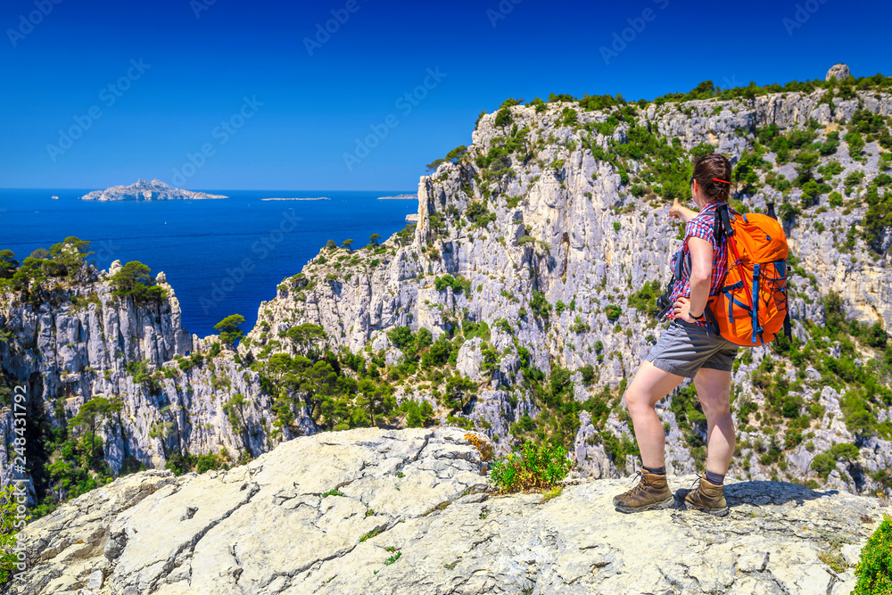 Sporty hiker woman enjoys her natural cliffs, sea and nature