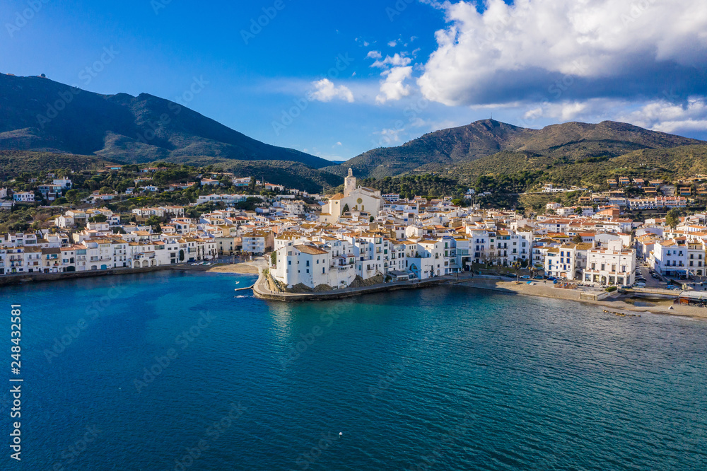 amazing aerial panoramic view photo of Cadaques small cizy city by the sea in Spain. Sunny day and big clouds. Mountains. Nature