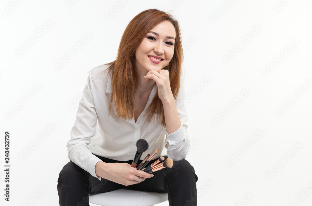 Makeup artist, beauty and cosmetics concept - Korean female make-up artist with makeup brushes on white background Makeup artist, beauty and cosmetics concept - Korean female make-up artist with makeup brushes on white background