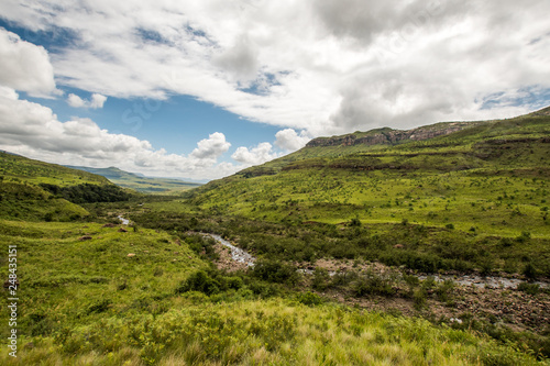 Fototapeta Naklejka Na Ścianę i Meble -  Hills and the Tugela River along the Tugela Gorge hiking route at the base of the Amphitheatre mountain. Drakensberg, South Africa