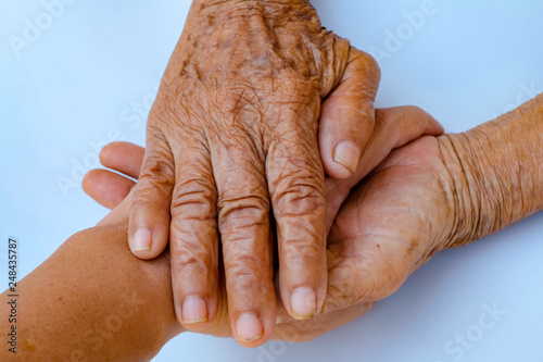 Old mother holding her son hand use for family day concept background