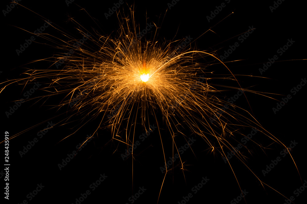 Bengal fire. New year sparkler candle on black background