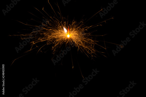 Bengal fire. New year sparkler candle on black background