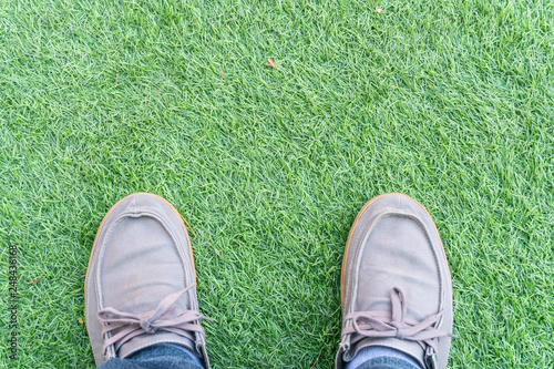 above view blue sneakers shoes on a green artificial grass
