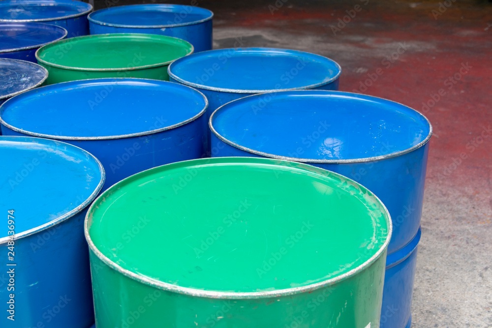 Recycled metal barrels painted in green and blue Recycled metal barrels painted in green and blue