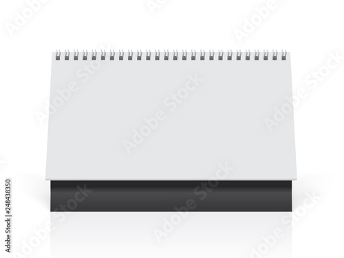 white paper calendar stands on the table