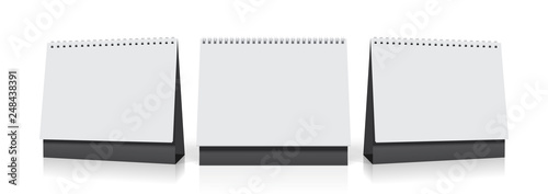white paper calendar stands on the table