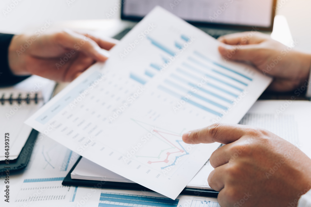 Two business people talking and analysis about finance budget company in office room. Two business people talking and analysis about finance budget company in office room.