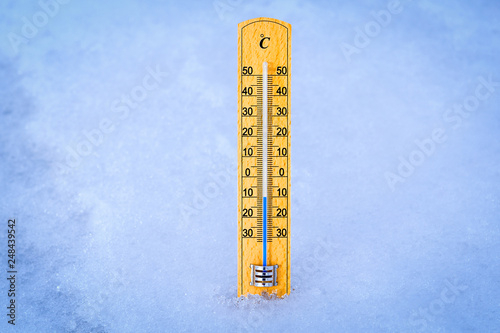 Outdoor thermometer in the snow. Thermometer display minus 10 degrees celsius