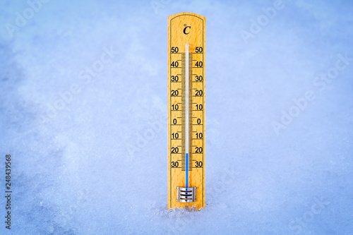 Outdoor thermometer in the snow. Thermometer display minus 20 degrees celsius