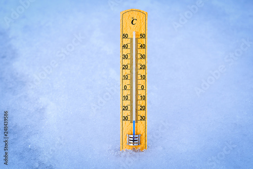 Outdoor thermometer in the snow. Thermometer display minus 30 degrees celsius