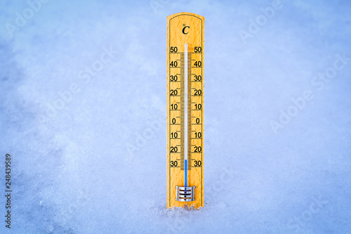 Outdoor thermometer in the snow. Thermometer display minus 25 degrees celsius