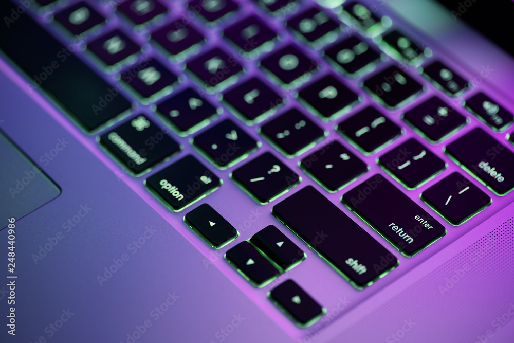 Keyboard laptop. Backlit computer keyboard closeup. Hi tech concept