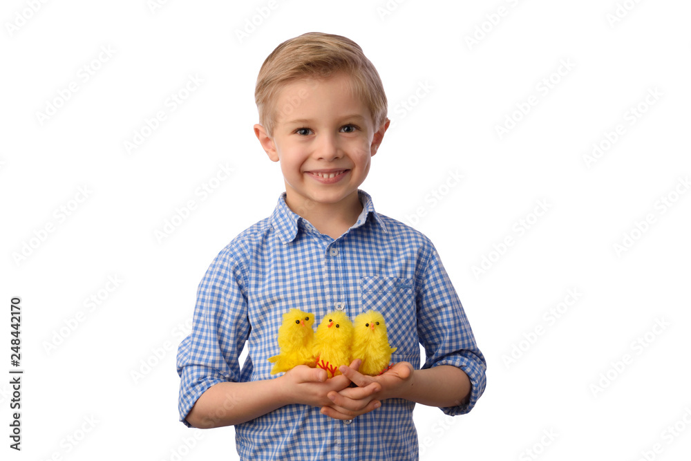 Easter and child. Boy and colorful Easter eggs in a small basket, yellow newborn chicken. White background.