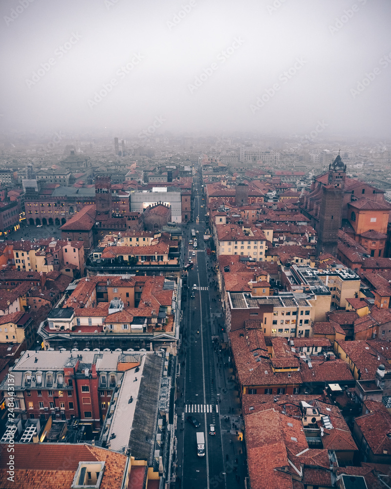 Bird's view of city center of Bologna from the peak of the Two Towers in foggy weather