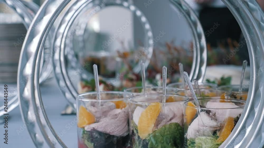 The waiters spread beautiful canapes and fruit on the banquet table The waiters spread beautiful canapes and fruit on the banquet table