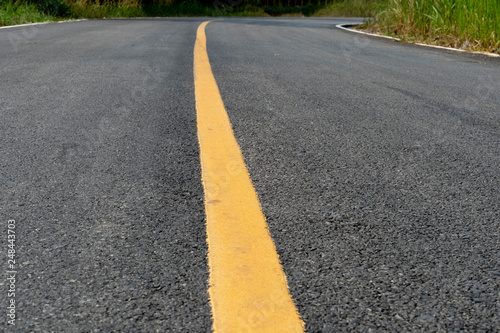 Country of asphalt curved road and yellow line. © thongchainak