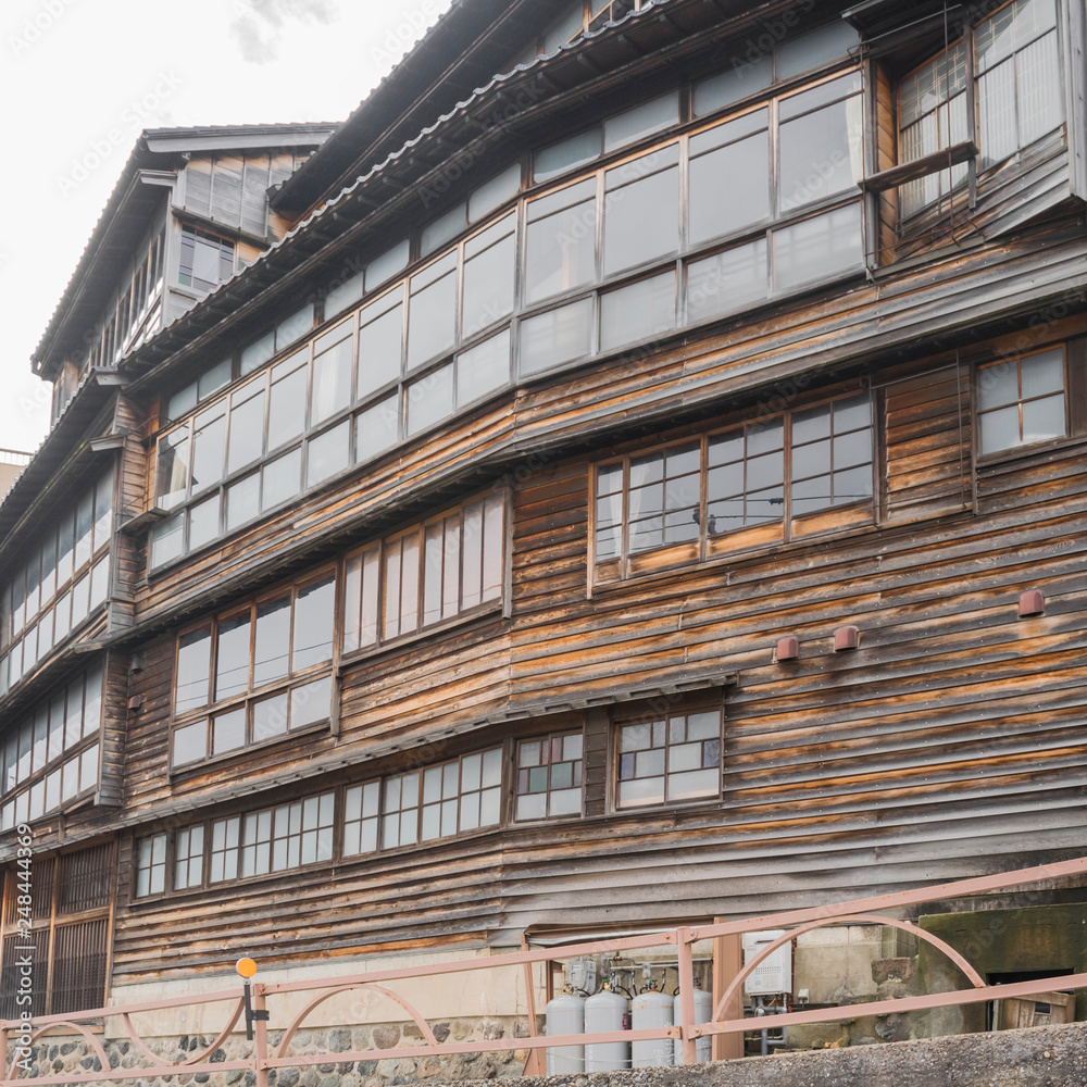 Detail of vintage Japanese wooden house with large windows in wooden frames in Kanazawa, Japan