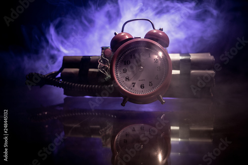 Image of a time bomb against dark background. Timer counting down to detonation illuminated in a shaft light shining through the darkness 