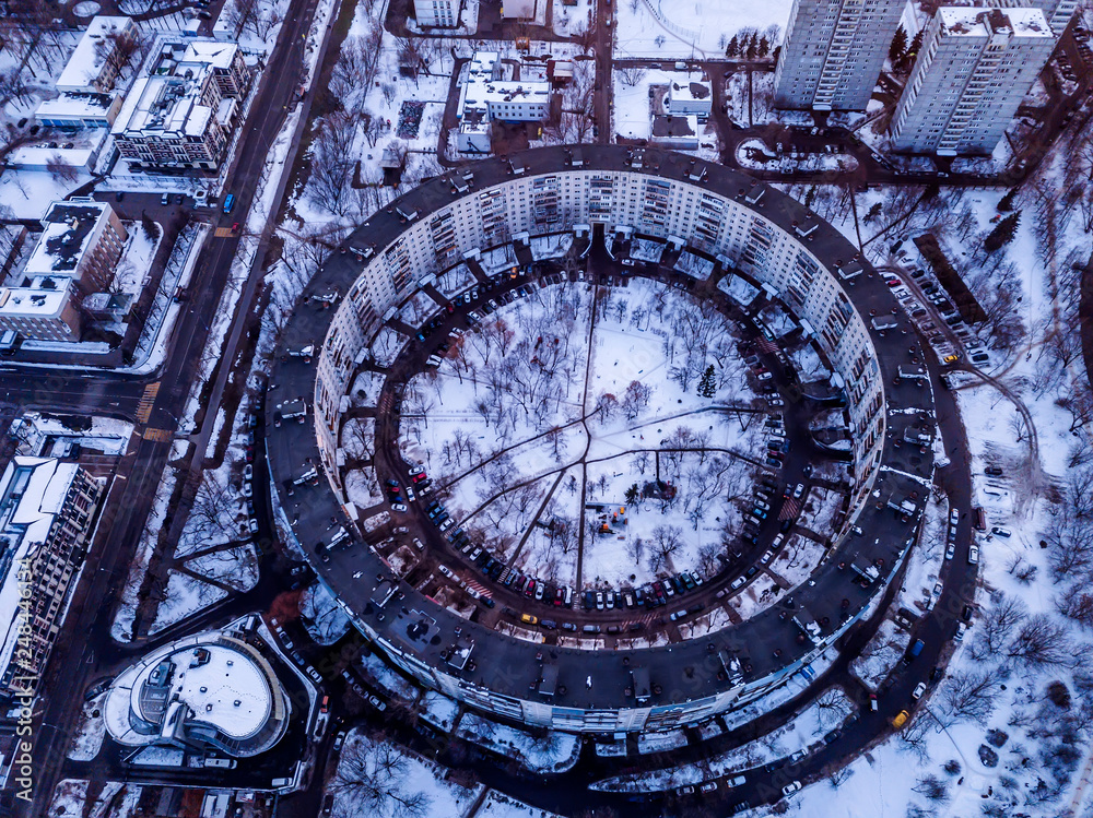Fototapeta premium Aerial view of a 9-storey residential building in the form of a ring built in the late 1970s. Moscow, winter.