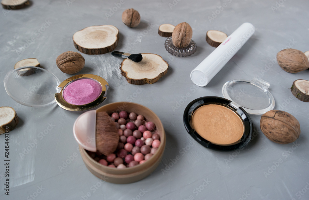 Makeup set on a gray background among the round wood Makeup set on a gray background among the round wood