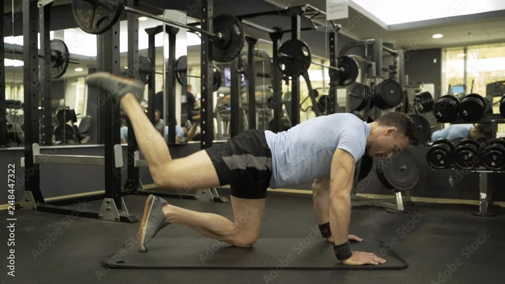 Image of a muscular man doing leg exercise at the gym. Image of a muscular man doing leg exercise at the gym.
