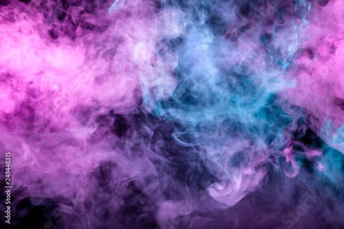Beautiful pattern of smoke on a black background from the evaporating waves in the neon light of pink blue and purple as sea pebbles in the foam for T-shirt.