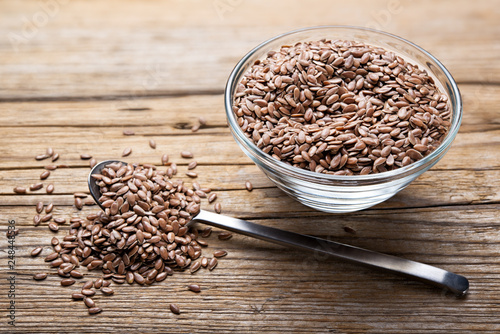 Flax seeds on wooden background