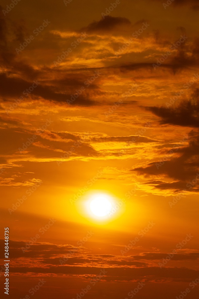 The sun and the orange sky with clouds sunrise or sunset background