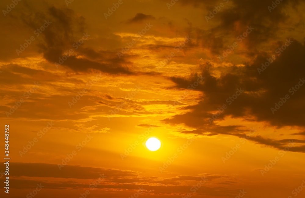 Panorama of golden hour sky with sun and clouds background
