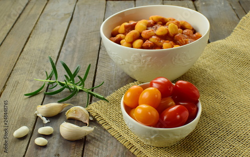 tomatoes and boiled beans in porcelain bowls