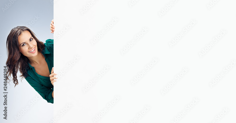 Beautiful young woman showing blank signboard Beautiful young woman showing blank signboard