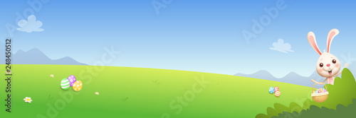 Easter bunny peeking behind bush and hunting decorated eggs - spring landscape background