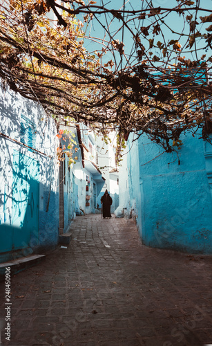 Gasse in Chefchaouen - Marokko der blauen stadt und einem Mann in der ferne photo