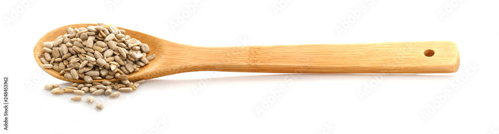 Peeled sunflower seed in a spoon. Isolated on white background. In raw form, you can eat. Peeled sunflower seed in a spoon. Isolated on white background. In raw form, you can eat.