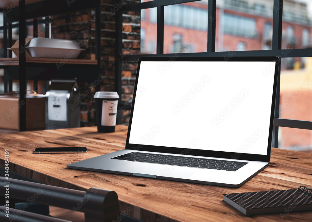 Laptop blank screen in loft interior office building Laptop blank screen in loft interior office building