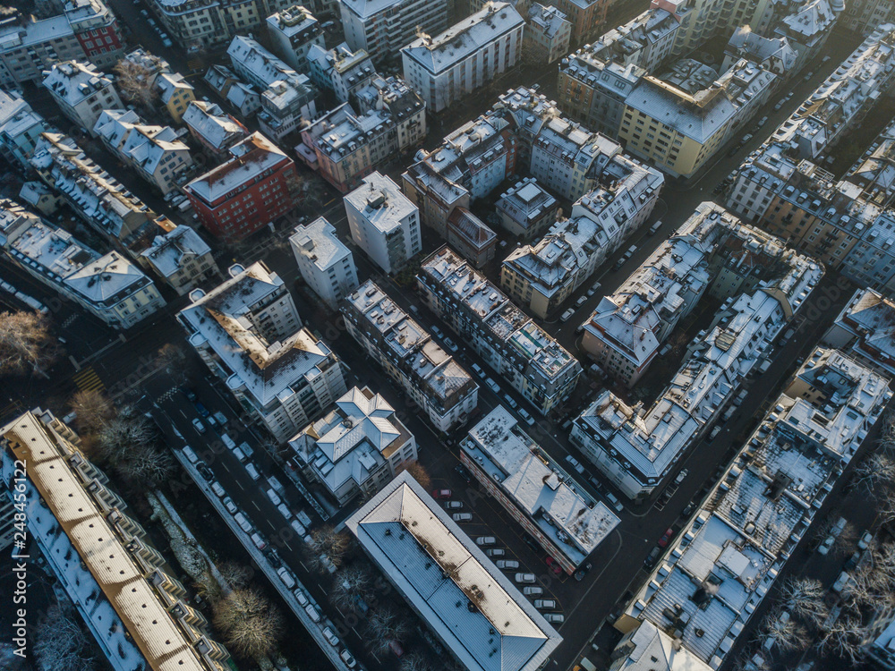 Aerial view of urban block buildings in top view. Pattern of architecture with roofs and streets. Aerial view of urban block buildings in top view. Pattern of architecture with roofs and streets.