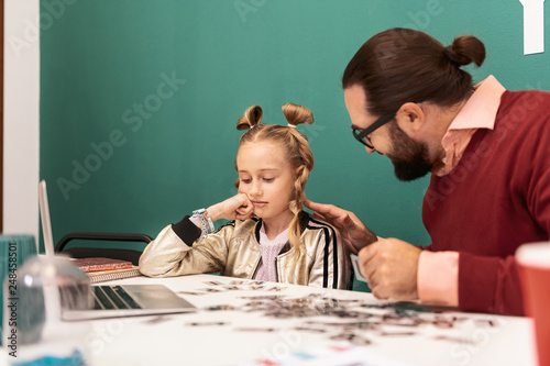 Pretty fair-haired girl with bracelets on her hand looking confused