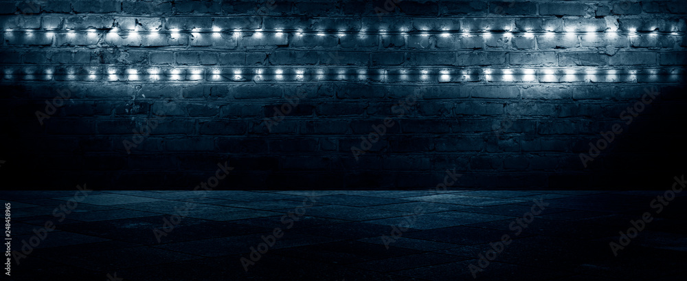 Old brick wall, dark room with brick wall, rays of searchlight light, illuminated night lights on an empty wall. Dark street, night city.