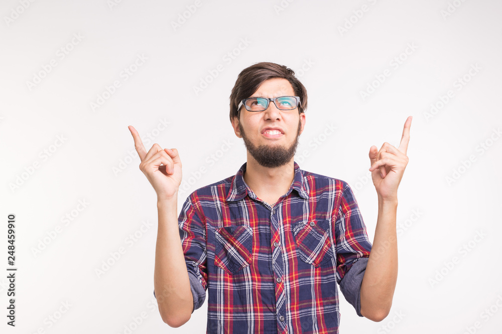 Expression and gesture concept - angry man pointing up over white background Expression and gesture concept - angry man pointing up over white background